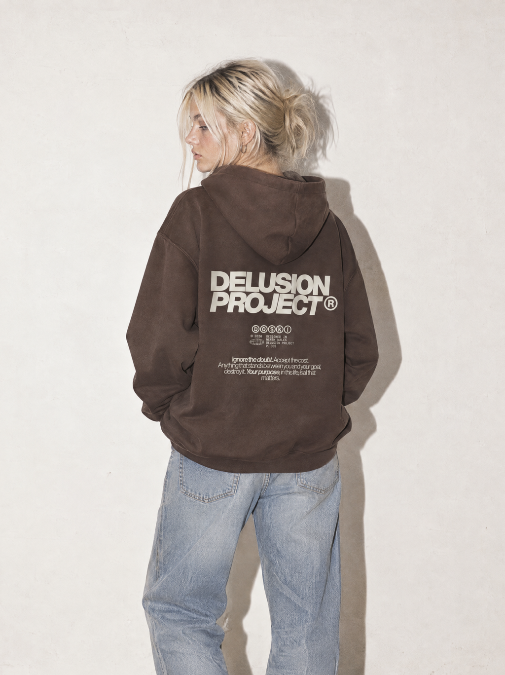 Model presentation: feminine; Shot: model image; Colour: Coffee; Head direction: left; Garment: heavyweight hoodie; Collection: The Delusion Project.

