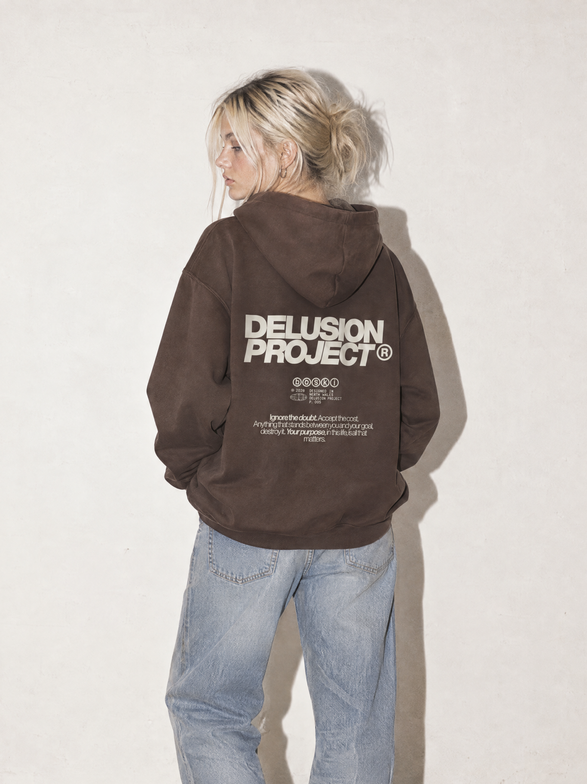 Model presentation: feminine; Shot: model image; Colour: Coffee; Head direction: left; Garment: heavyweight hoodie; Collection: The Delusion Project.

