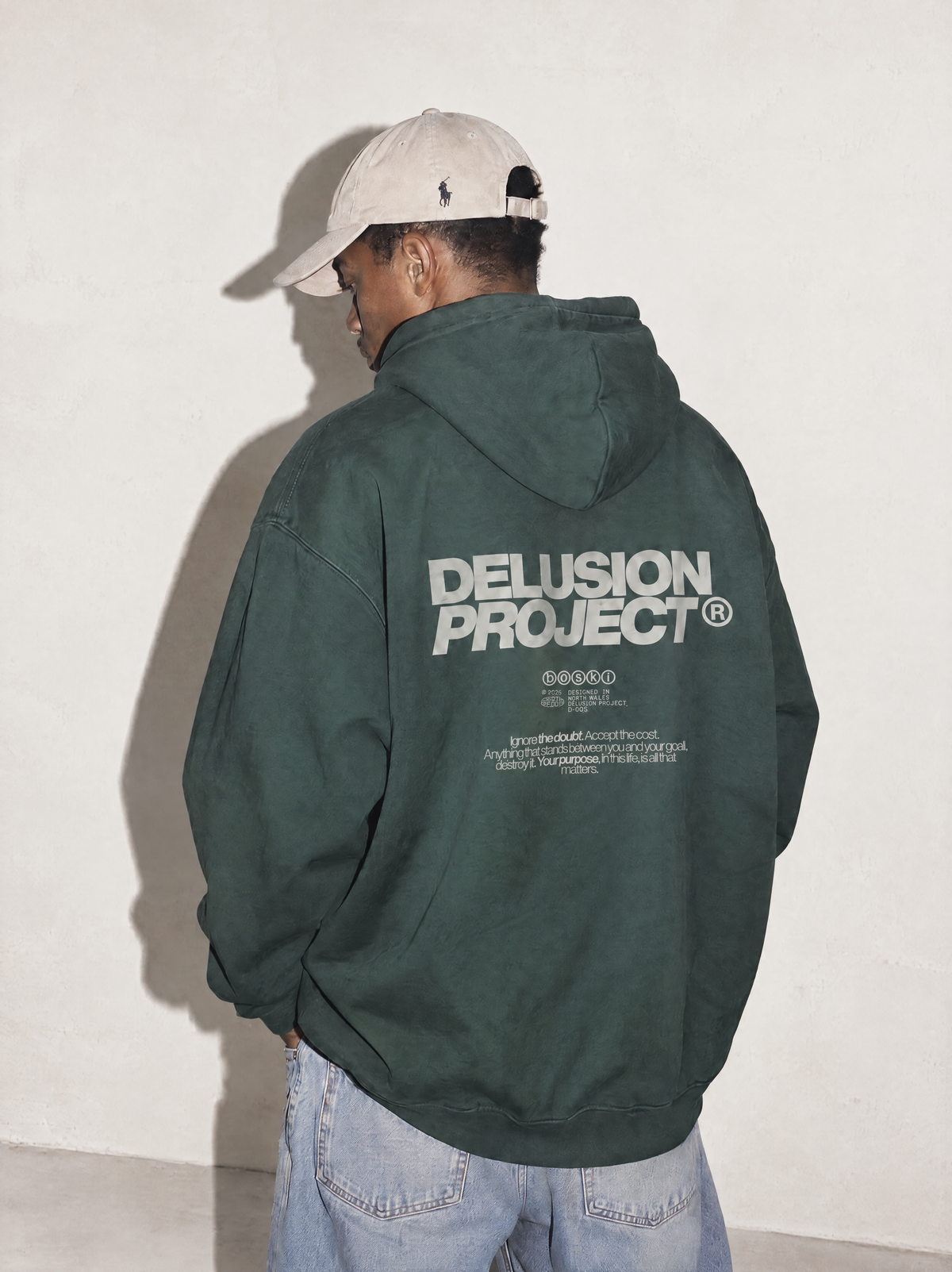 Model presentation: masculine; Shot: model image; Colour: Retro Green; Head direction: left; Garment: heavyweight hoodie; Collection: The Delusion Project.

